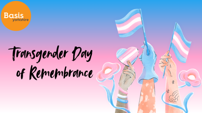 Graphic with hands holding transgender flags and flowers coloured white, pink and light blue. Basis Yorkshire logo. Text: Transgender Day of Remembrance